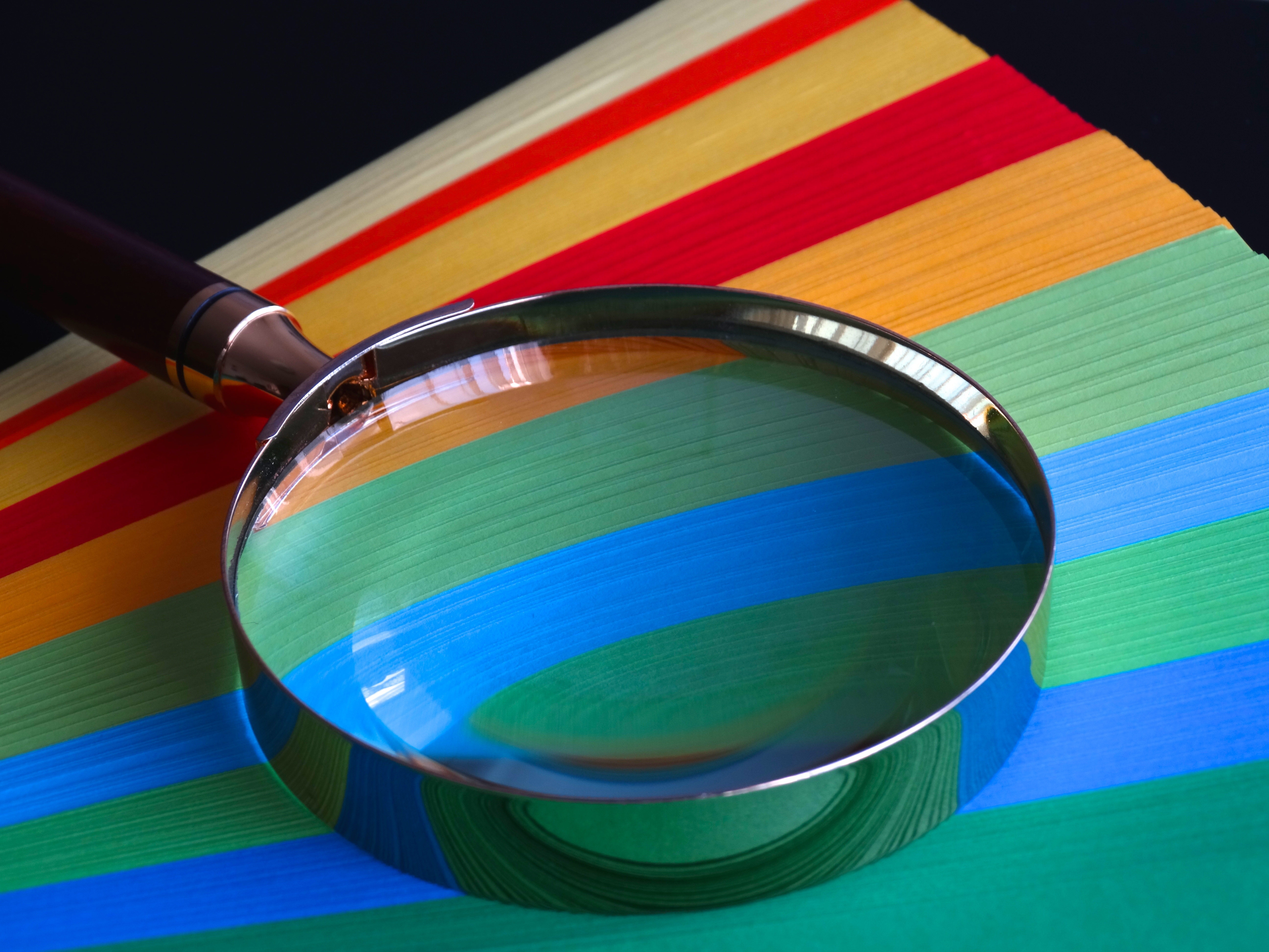 Magnifying Glass on Top of Multicoloured Background