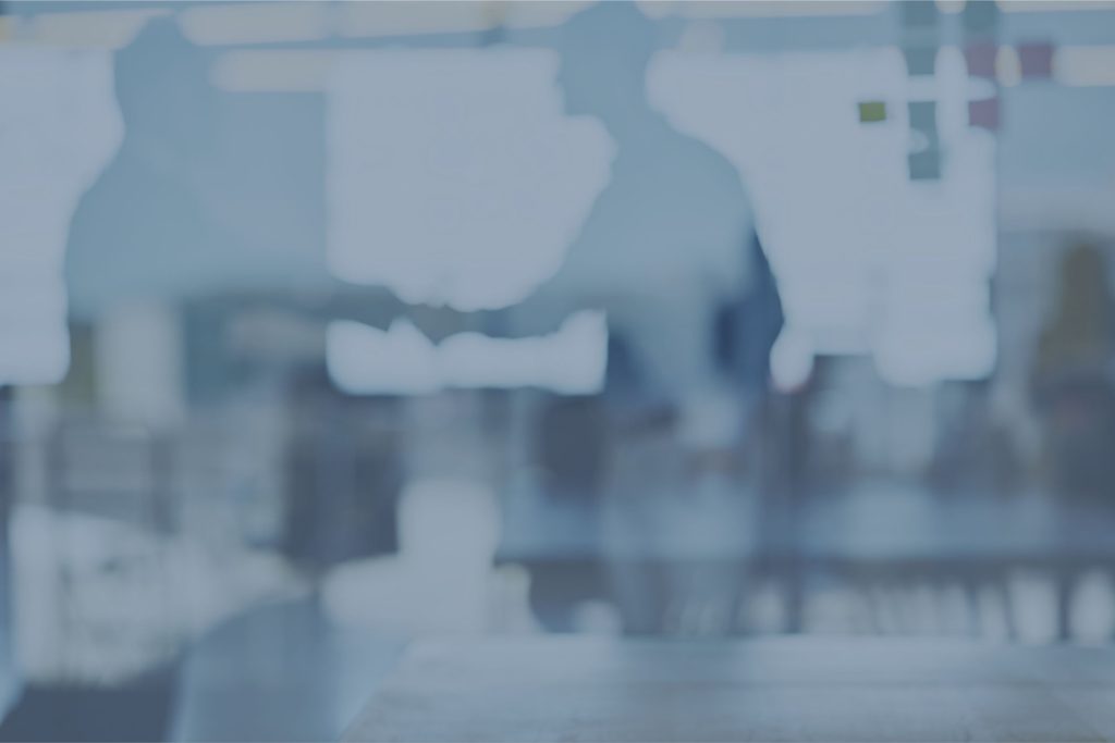 Business handshake blurred office